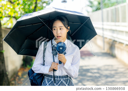 High school girl holding a parasol High school girl holding a parasol 130866938