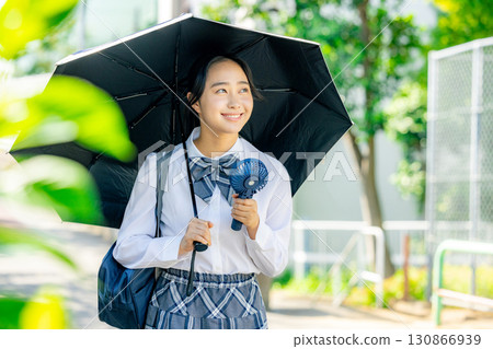High school girl holding a parasol High school girl holding a parasol 130866939