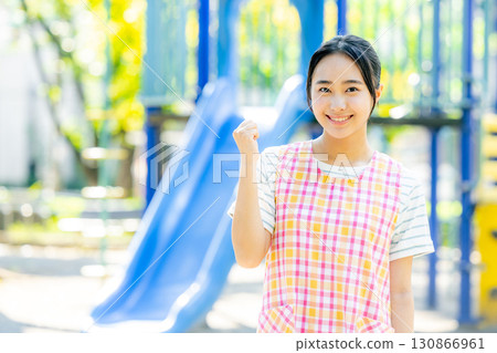 Nursery teacher playing in the park 130866961