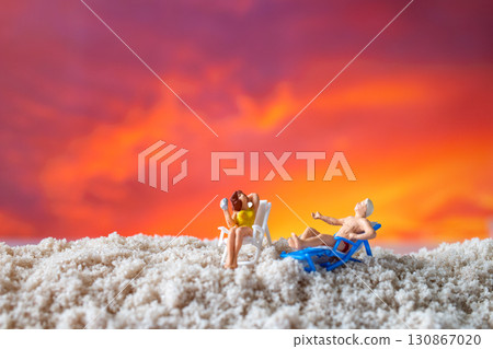 Miniature Couple Relaxing on Beach Chairs at Sunset Miniature Couple Relaxing on Beach Chairs at Sunset 130867020