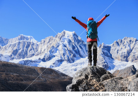 Successful woman hiking on high altitude mountain top Successful woman hiking on high altitude mountain top 130867214