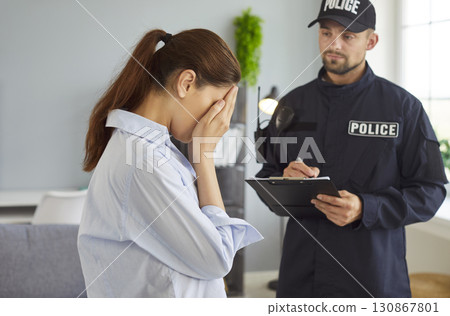 Crying Woman Talking To Police Officer 130867801