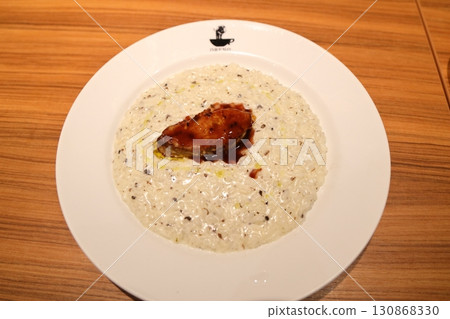 Truffle-studded cheese risotto served with foie gras Truffle-studded cheese risotto served with foie gras 130868330
