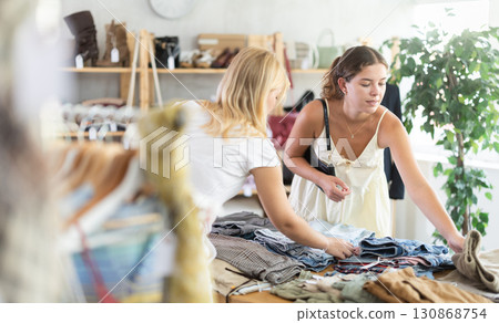 Two women choosing pants in a store 130868754