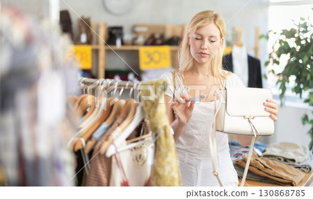 Woman choosing a handbag on sale Woman choosing a handbag on sale 130868785