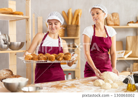 Typical day at the bakery - preparing dough and croissants 130868802