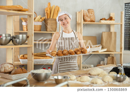 Teenage girl with fresh croissants in bakery 130868869