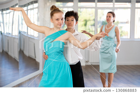 Passionate teen dancers, girl and boy practicing ballroom dancing in studio 130868883