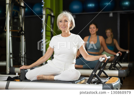Portrait of a mature woman in a Pilates workout 130868979