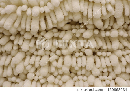 A CloseUp Photo of Textured Fabric Featuring Soft Tufts for Enhanced Visual Interest A CloseUp Photo of Textured Fabric Featuring Soft Tufts for Enhanced Visual Interest 130868984
