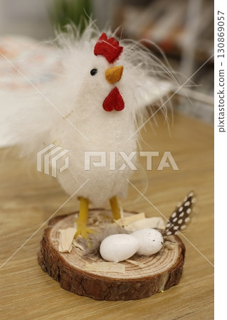 Adorable and charming Easter Decoration featuring a lovely Chicken and a cozy Nest 130869057