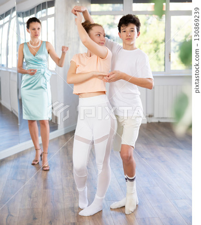 Girl and boy dancing slow ballroom dance in choreography studio 130869239