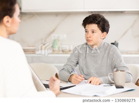 Boy studying with tutor 130869275