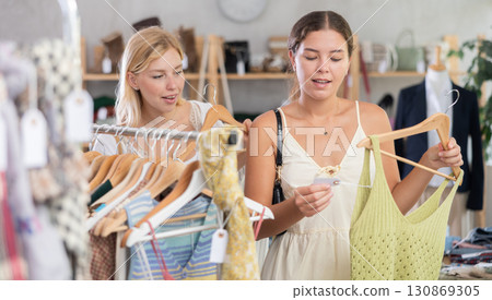 Two women shopping in a clothing store 130869305