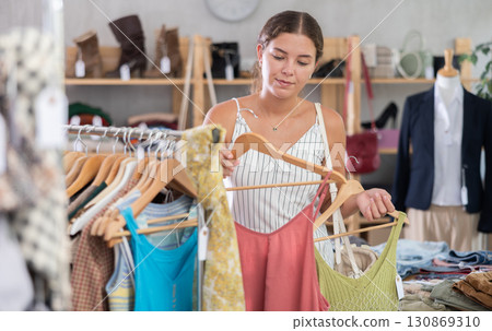 Young woman shopping in clothing store Young woman shopping in clothing store 130869310