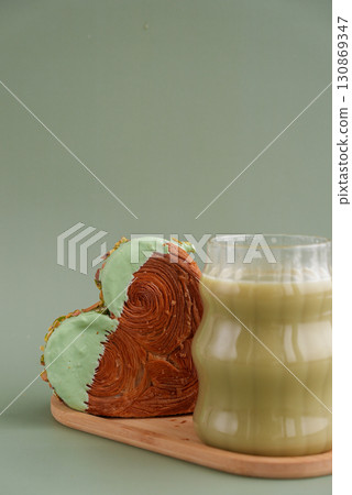 Nutrient-rich matcha drink with Green latte Matcha tea coffee with Delightful and vibrant heartshaped pastry croissant treat, beautifully topped with colorful frosting nut galore. Mock up template 130869347