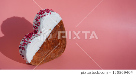 Heart shaped white chocolate croissant on pink background with copy space. Puff pastry new trendy sweet dessert bakery. Creamy dough Heart shaped white chocolate croissant on pink background with copy space. Puff pastry new trendy sweet dessert bakery. Creamy dough 130869404