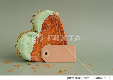 Empty paper note template mock up Delicious fresh croissant topped with Matcha Green Tea flavor Ganache. Creation unique heart shape bakery. Puff pastry holiday love gift present idea Valentine's day Empty paper note template mock up Delicious fresh croissant topped with Matcha Green Tea flavor Ganache. Creation unique heart shape bakery. Puff pastry holiday love gift present idea Valentine's day 130869407
