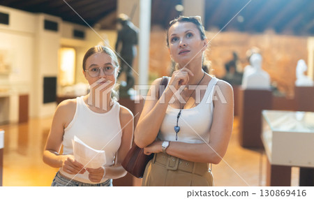 Woman and teenage girl looking at sculpture hall Woman and teenage girl looking at sculpture hall 130869416