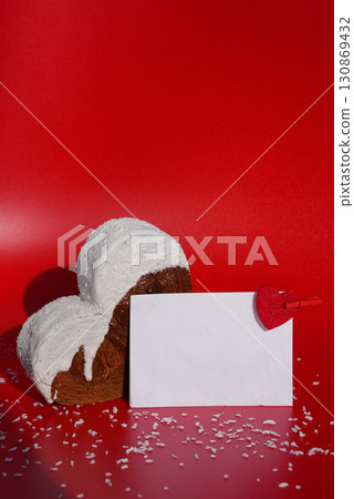Empty paper note template sample mock up blank for wishes greeting holiday card Heartshaped pastry croissant treat topped with colorful frosting galore. Food experimentation viral dessert baking trend 130869432