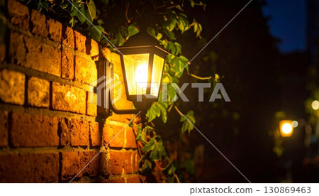 Antique glass bulb lantern on an old brick wall street at night Antique glass bulb lantern on an old brick wall street at night 130869463