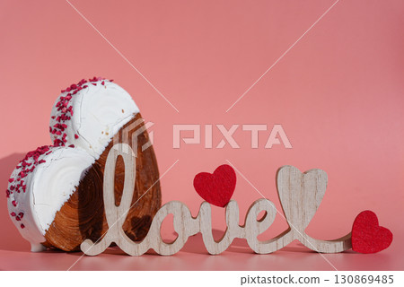 Wooden word LOVE decor Valentine's Day Birthday proposal holiday present gift idea Delightful and vibrant heartshaped pastry croissant treat, beautifully topped with colorful frosting galore. Copy 130869485