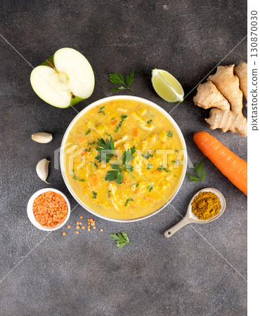 Indian Mulligatawny soup with ingredients on gray background. Top view. Indian food. 130870030