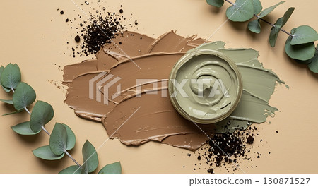 Natural Display of Earth-Toned Creams with Soil and Eucalyptus Leaves on Beige 130871527