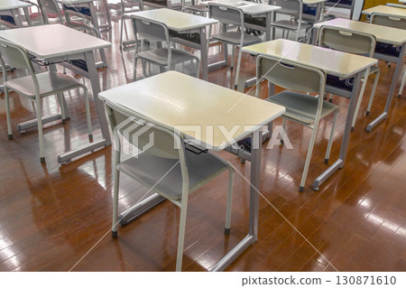 Desks and chairs lined up in an empty classroom, image of a school and classroom Desks and chairs lined up in an empty classroom, image of a school and classroom 130871610