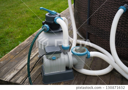 The pump used in the pool's filtering and ozonation setup to ensure clear outdoor water. 130871632