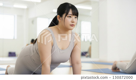 Fat woman doing yoga exercises 130872000