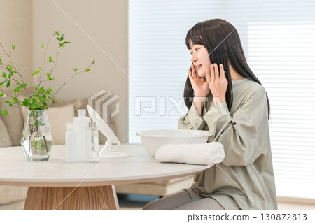 Young Asian woman washing her face, doing skin care 130872813