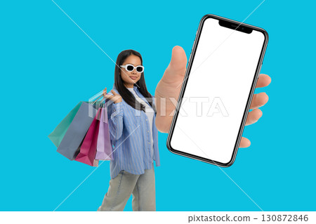 Young shopper enjoys great deals while holding shopping bags Young shopper enjoys great deals while holding shopping bags 130872846