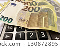 Calculator and Euro Bills. A professional stock photo of 200 euro banknotes on a calculator. 130872895