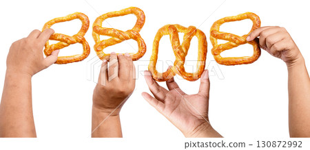 Collection set of human hands holding a salty baked brown pretzel isolated over a white background. Oktoberfest festival Collection set of human hands holding a salty baked brown pretzel isolated over a white background. Oktoberfest festival 130872992