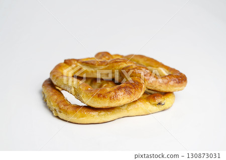 Salty baked brown pretzel isolated over a white background. Oktoberfest festival 130873031