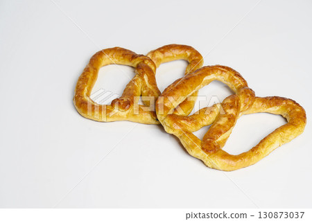 Salty baked brown pretzel isolated over a white background. Oktoberfest festival Salty baked brown pretzel isolated over a white background. Oktoberfest festival 130873037