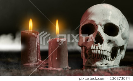 Human head skull with fire candles for ritual at a dark creepy scene background. Concept of Spooky Halloween Human head skull with fire candles for ritual at a dark creepy scene background. Concept of Spooky Halloween 130873074
