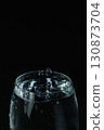 Water overflowing from the glass 130873704
