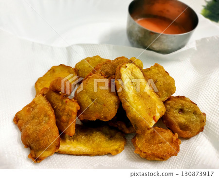 Banana Fritters Served with Spicy Red Chutney Banana Fritters Served with Spicy Red Chutney 130873917