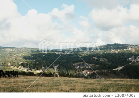 Panoramic view of Divcibare, Serbia, with ski lifts, forests and scattered houses under a bright sky. Popular mountain resort in the Balkans 130874302