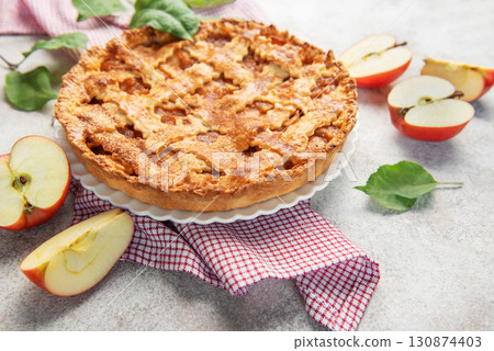 Delicious homemade apple pie decorated with fresh apple slices and leaves 130874403