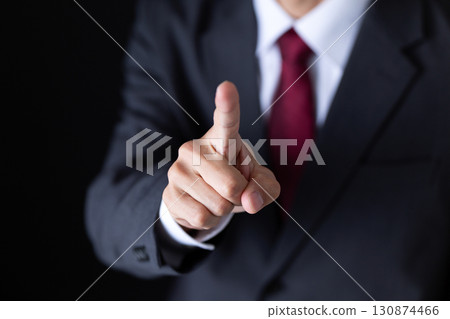 Middle-aged male businessman in a suit pointing 130874466