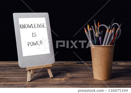 White tablet with the words knowledge is power written on it White tablet with the words knowledge is power written on it 130875104