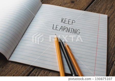 Notebook with pencils and the words keep learning written on it Notebook with pencils and the words keep learning written on it 130875107