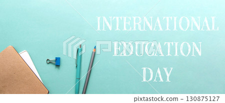 International education day. A blue background with a pencil and pen on it. 130875127