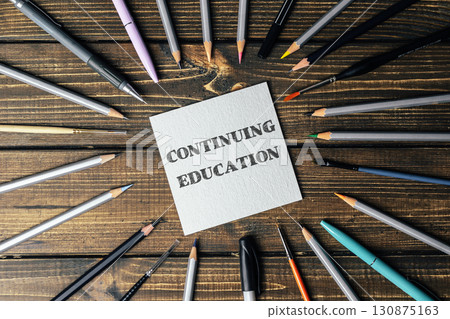 Circle of pencils and pens with the word continuing education written in the center Circle of pencils and pens with the word continuing education written in the center 130875163