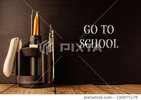 Black desk with a pencil holder and a pencil sharpener 130875179