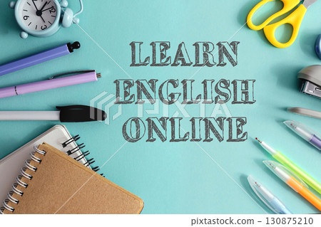 Blue background with a clock, scissors, pens, and a notebook 130875210