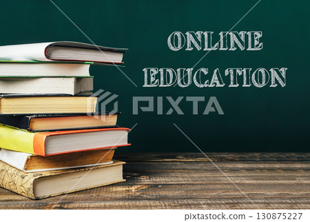 A stack of books with the word online education written on top 130875227